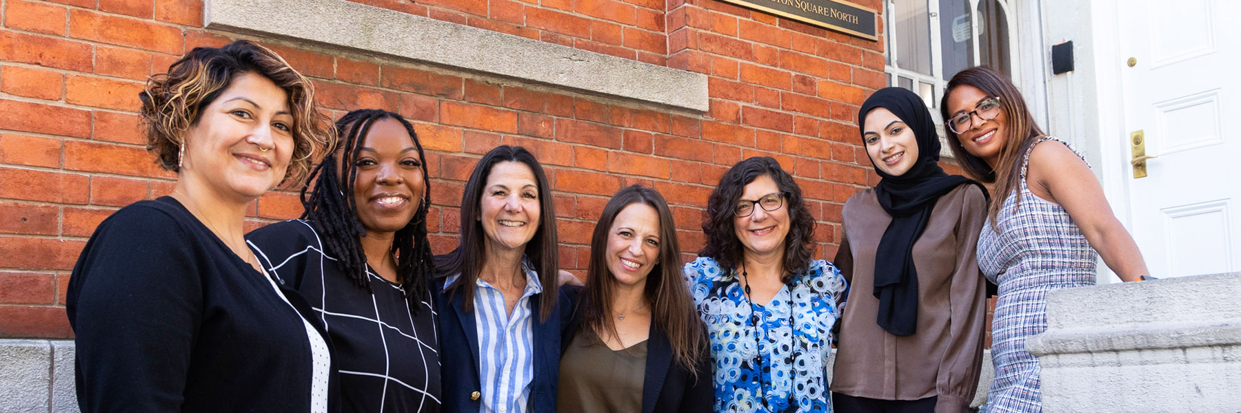 Group photo of NYU Silver's Enrollment Services team in front of 1 Washington Square North